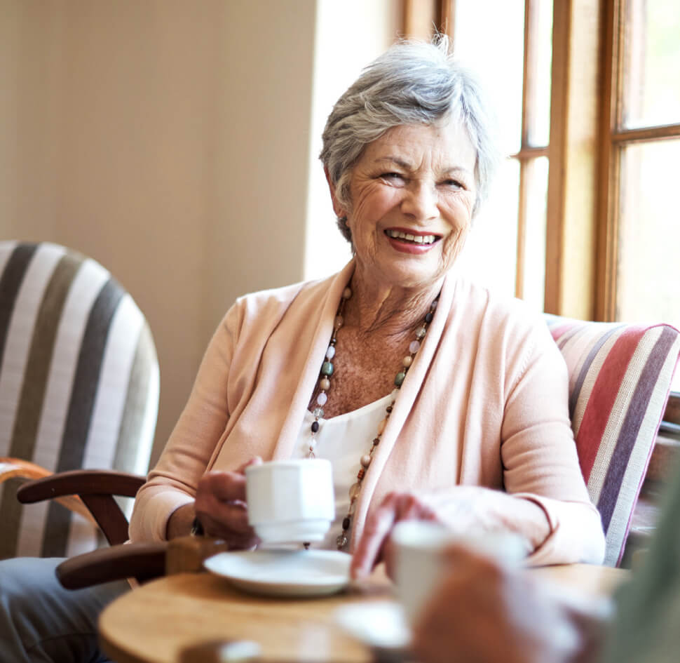 senior woman drinking tea with a friend