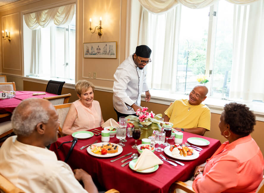 seniors being served dinner