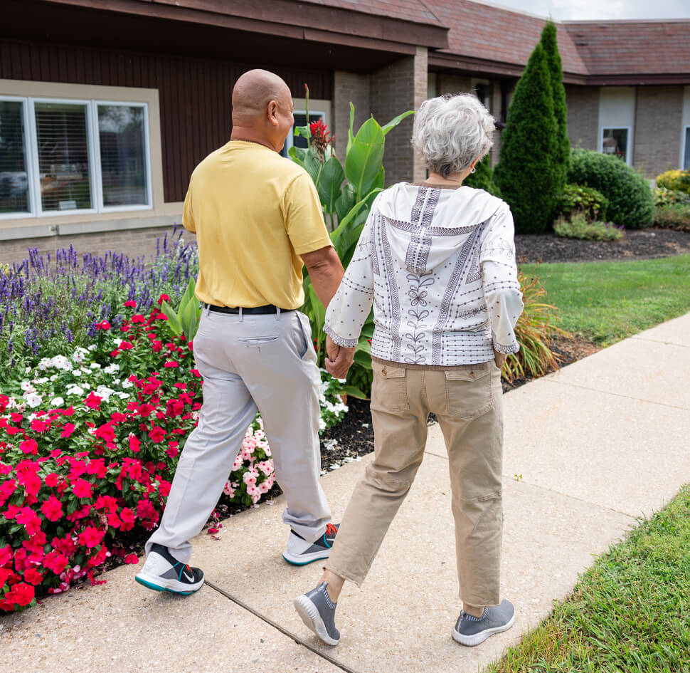 Senior couple walking on Shipley grounds
