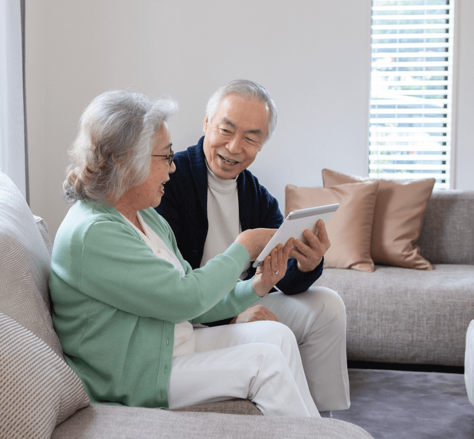 senior couple on tablet in their home