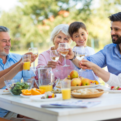Family clinking glasses at breakfast