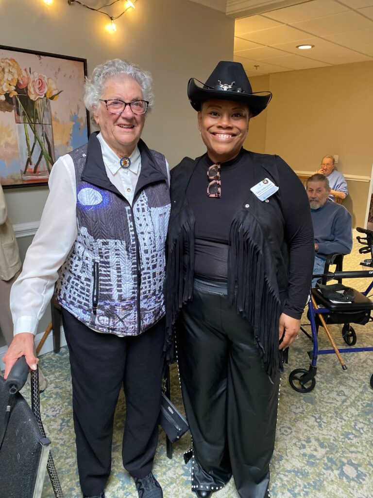 Judy Joesph and team member in costume standing and smiling at an event